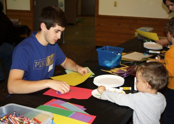 Iowa State University Student doing crafts with two small kids