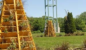 flower tower in the campaniel garden with planted beds and a decorative campanile sculpture behind it