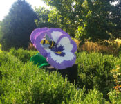 sculpture exhibit of a large sculpture that looks like a pansy that is made of lego bricks
