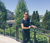 botanical garden intern smiling in front of the Des Moines Botanical Garden