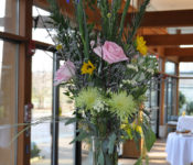 education program floral arrangement in whites, yelows and pink colored flowers