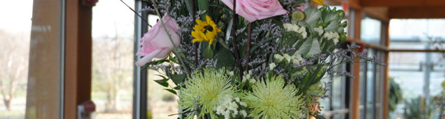 education program floral arrangement in whites, yelows and pink colored flowers