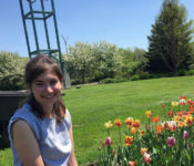 reiman gardens intern smiling in front of our tulips
