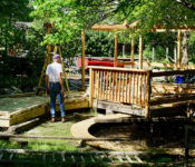 volunteer rebuilding the reflection garden at reiman gardens