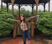 Reiman Gardens intern smiling with her arms in the air