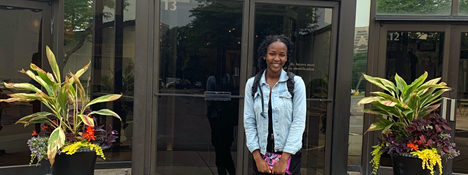 Reiman Gardens interns smiling outside a gif shop mart