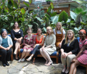 Photo of Reiman Gardens interns sitting and smiling in the conservatory