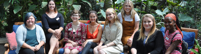 Photo of Reiman Gardens interns sitting and smiling in the conservatory