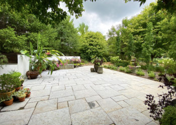 outdoors in the Pattern Garden with a paved surface and various planted containers