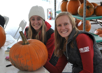 young adults volunteering to carve pumpkins